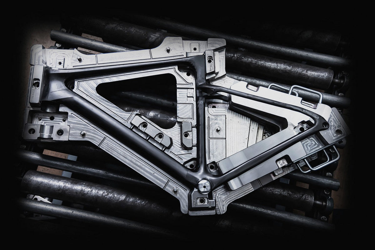Opened one-piece frame mold resting on steel tubing
