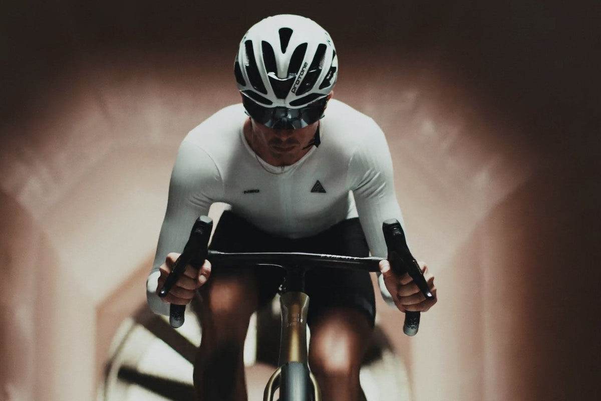 Rider front-on at speed, tunnel walls blurred behind